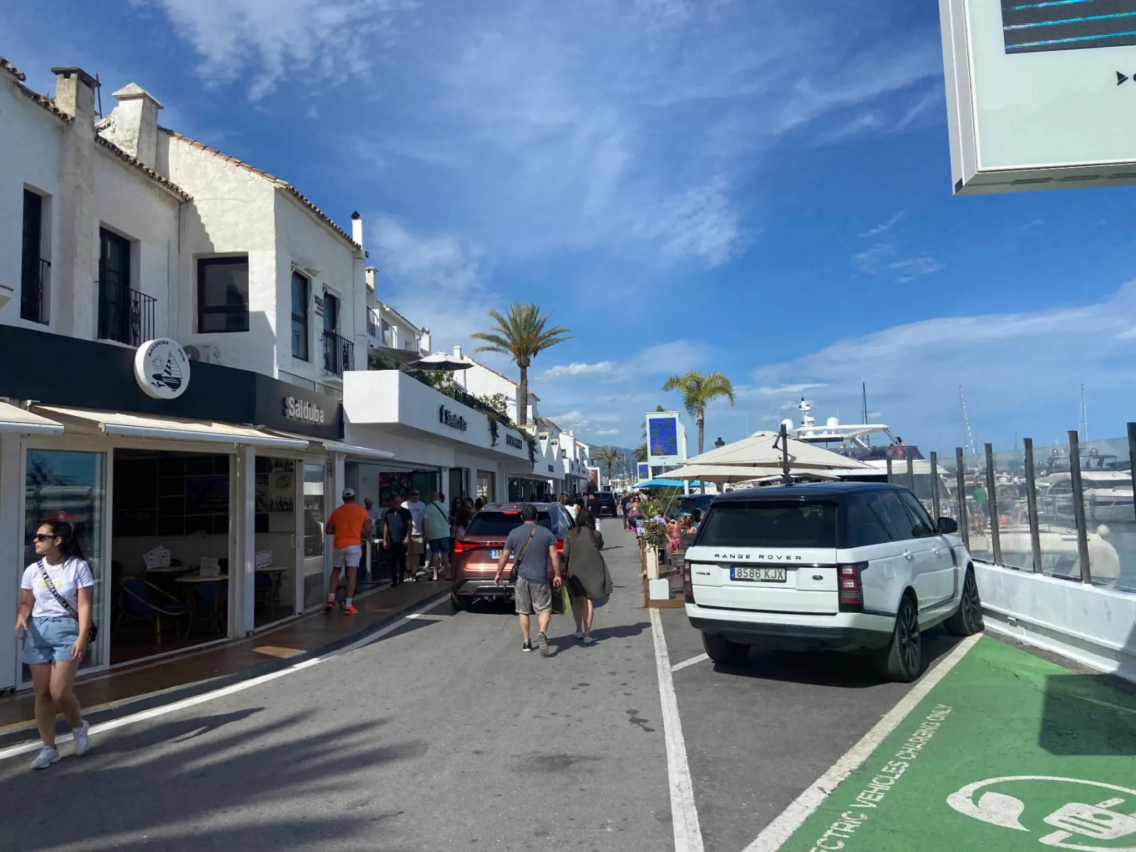 Luxury cars parked along a designer shopping street in Puerto Banús