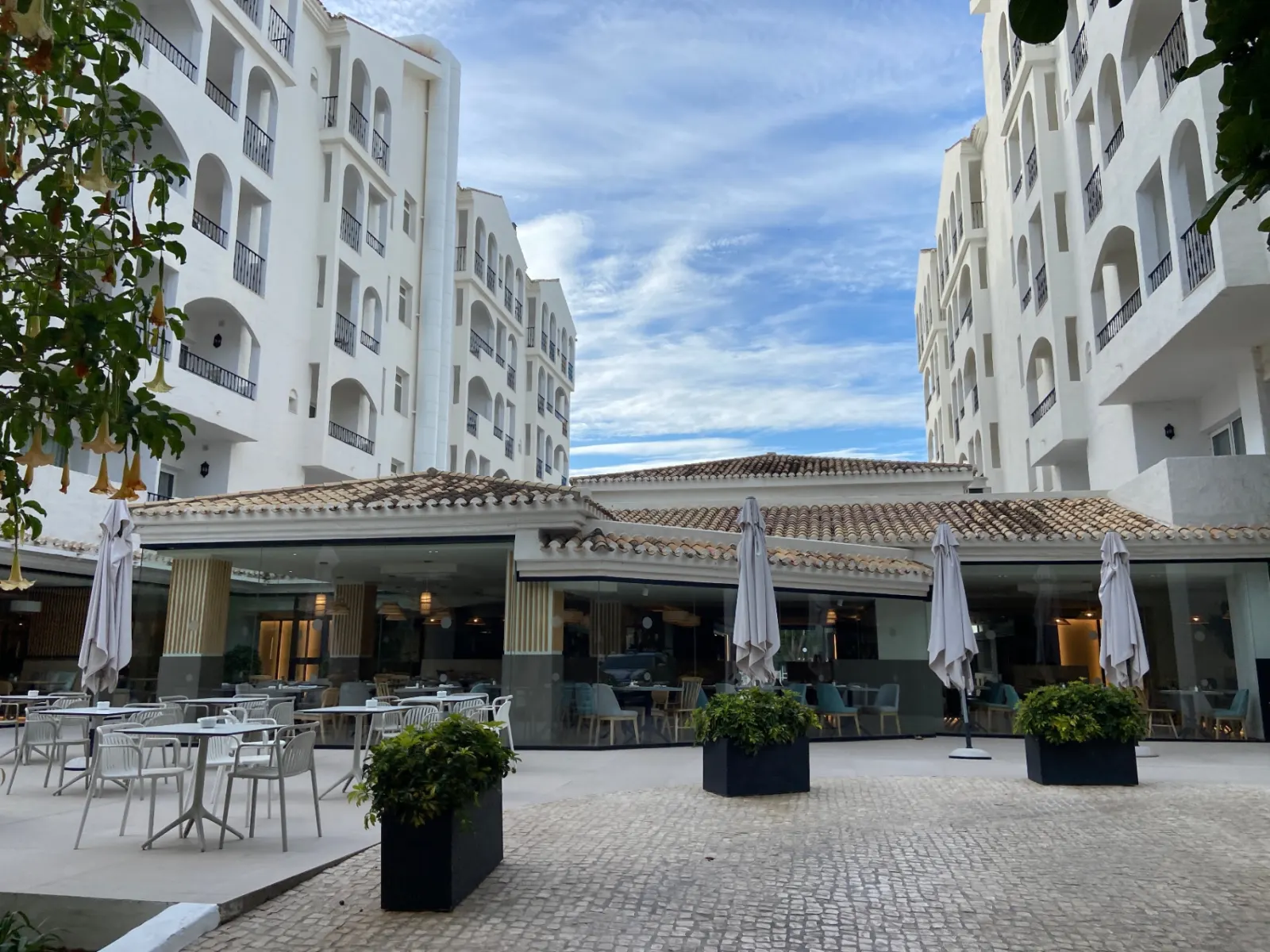 Whitewashed Andalusian hotel courtyard with terrace dining in Puerto Banús